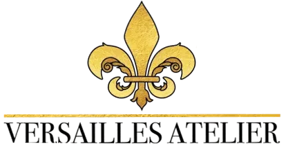 The logo for versailles atelier has a fleur de lis on it.