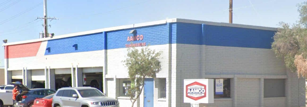 Building with blue and red stripe trim; sign reads