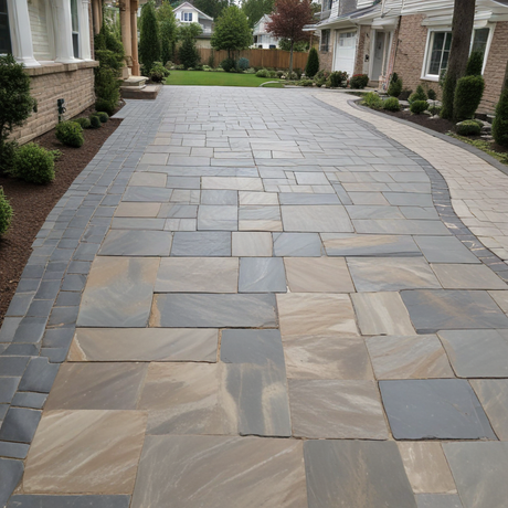 A brick driveway leading to a brick house