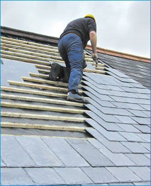  Roofer fitting a slate roof