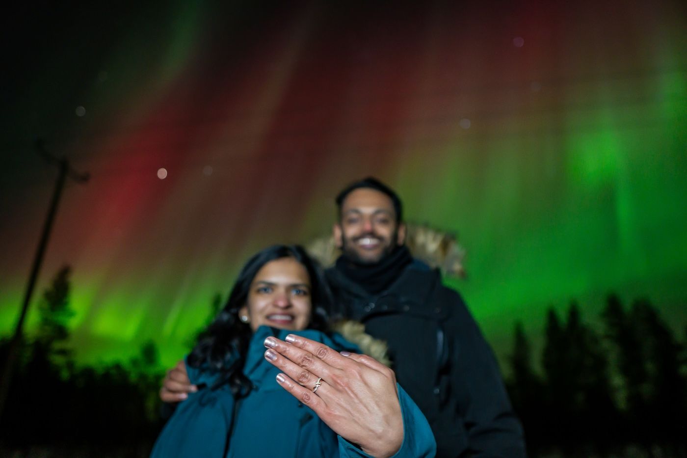 Close-up of couple celebrating under the Aurora after engagement with Arctic GM