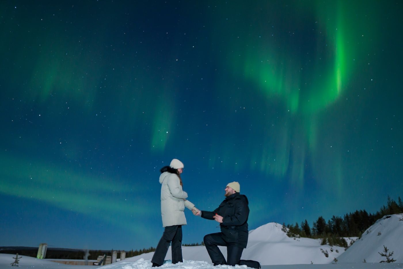Surprise proposal beneath the Aurora during Arctic GM Northern Lights tour in Levi, Finland