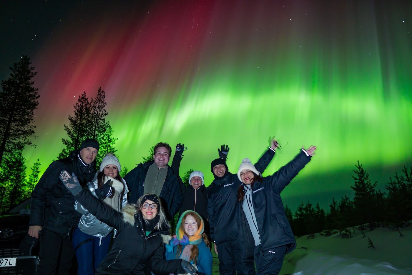 Group celebrating Northern Lights with Arctic GM on a photography tour in Levi, Lapland