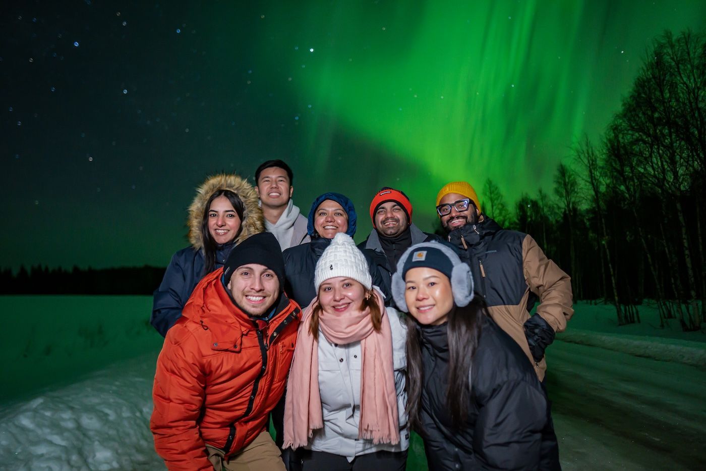 Group photo after successful Aurora hunt during Arctic GM tour in Rovaniemi, Finland