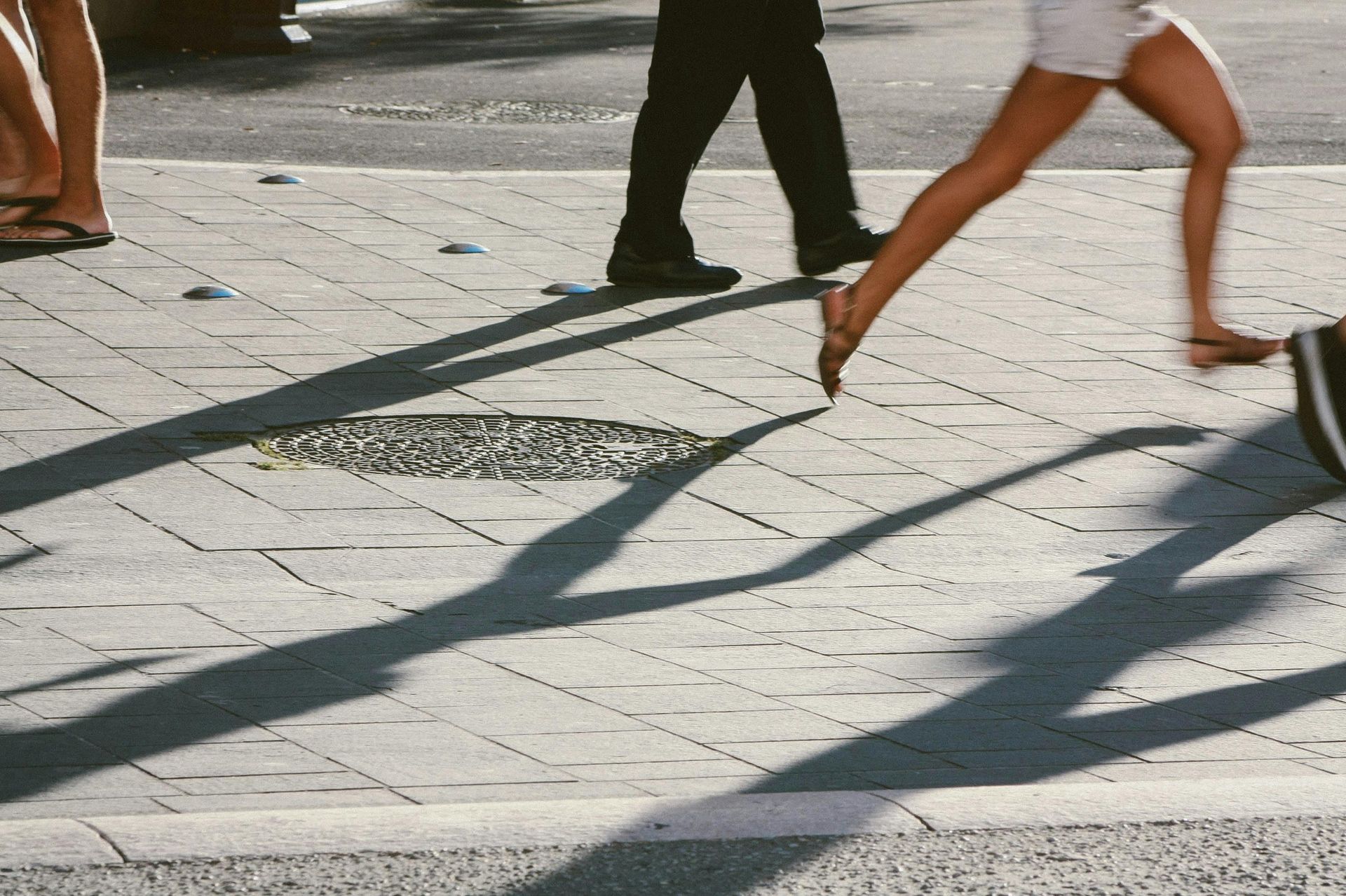 A group of people are working on a sidewalk.