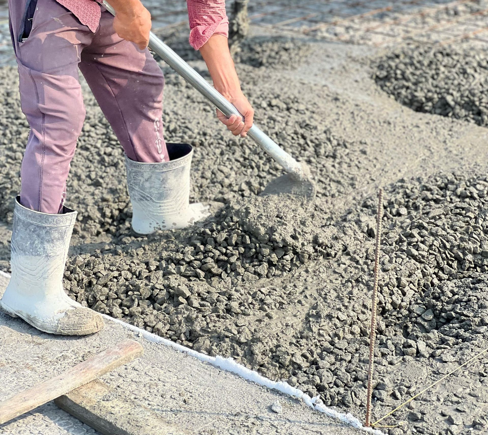 A group of people are working on a sidewalk.