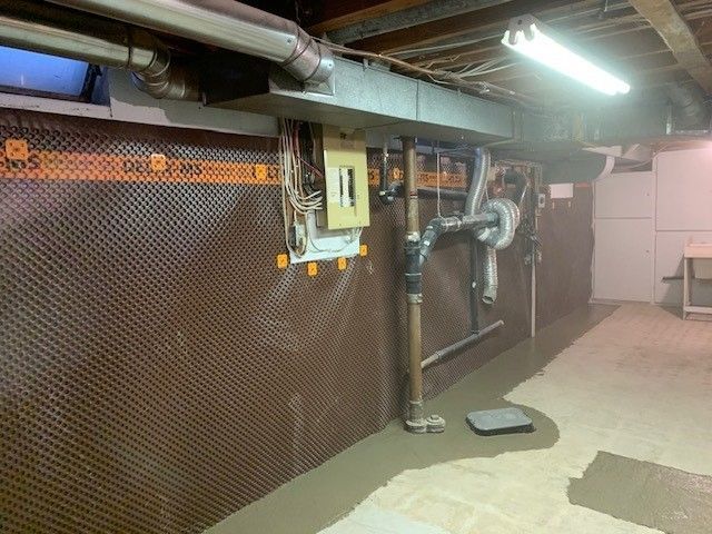 Basement with Pipes and a Light on the Ceiling — Oldcastle, ON — Water Loc Inc