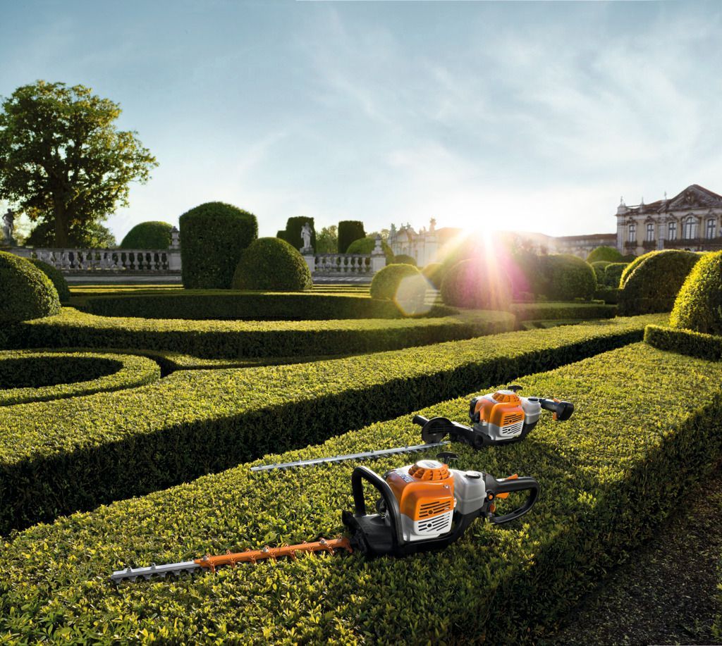 Two Stihl Hedge Trimmers Are Sitting in A Garden — Stihl Shop Grafton in Woolgoolga, NSW