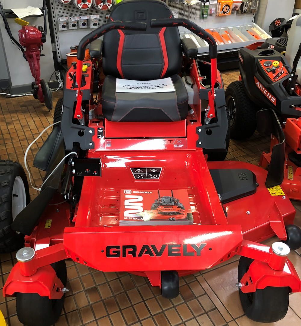 A Red Gravely Lawn Mower Is Parked in A Store — Stihl Shop Grafton in Woolgoolga, NSW