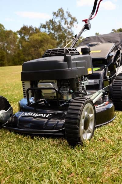 A Black Lawn Mower Is Sitting on Top of A Lush Green Field — Stihl Shop Grafton in Grafton, NSW