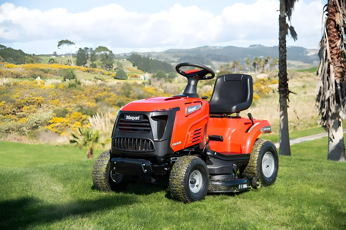 Red Riding Lawn Mower on a Grassy Lawn, with Hills and Trees in the Background