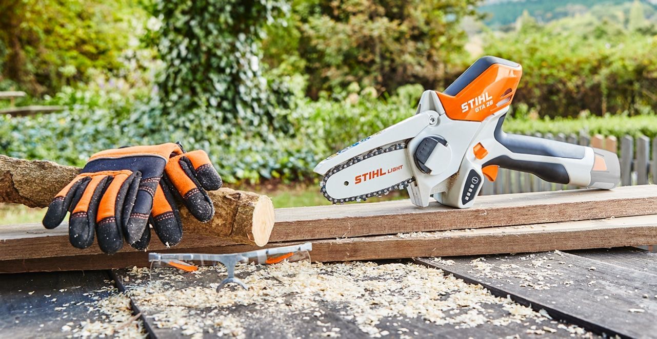 A Person Is Cutting a Piece of Wood with A Chainsaw — Stihl Shop Grafton in Grafton, NSW
