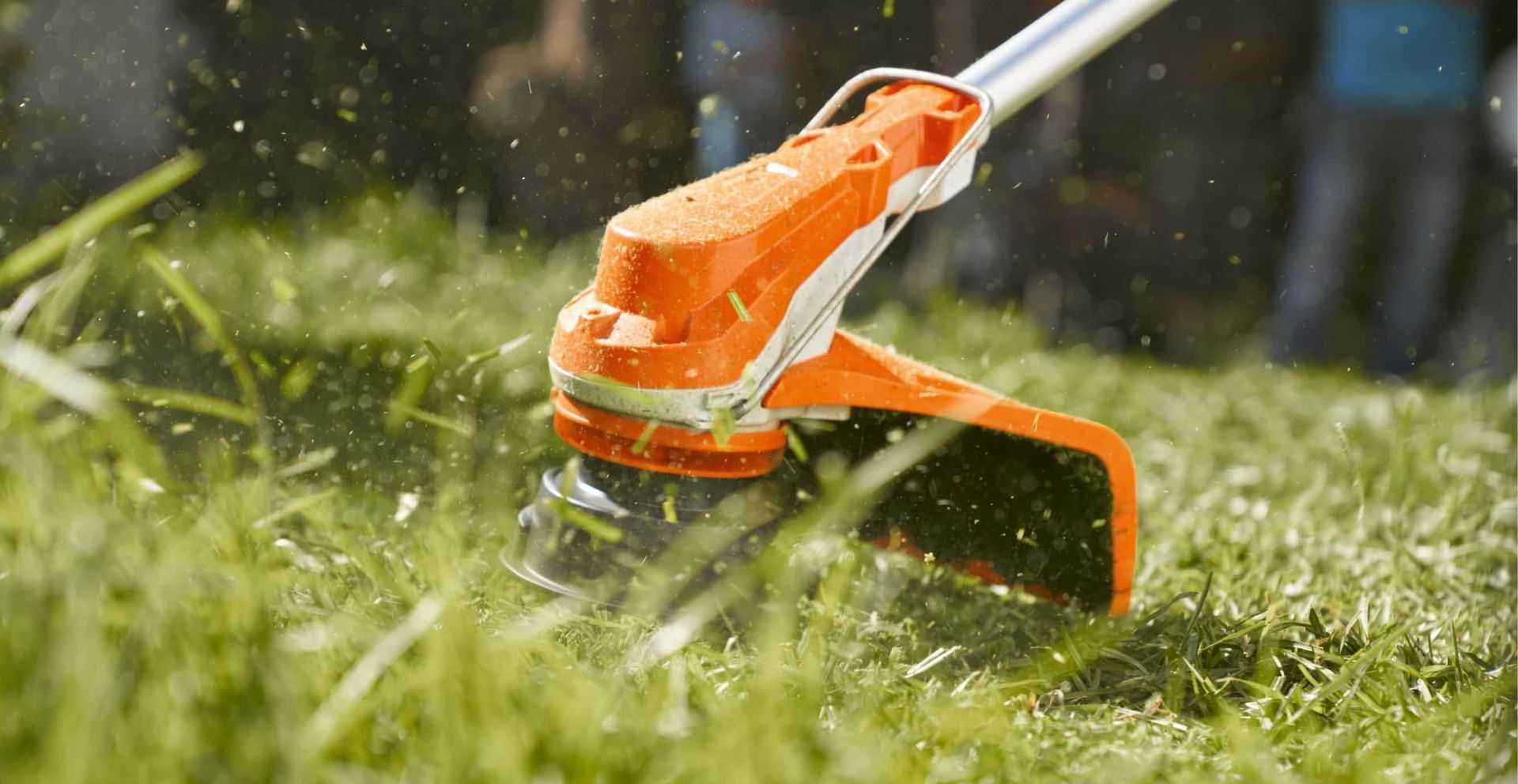 A Person Is Using a Lawn Mower to Cut the Grass — Stihl Shop Grafton in Grafton, NSW