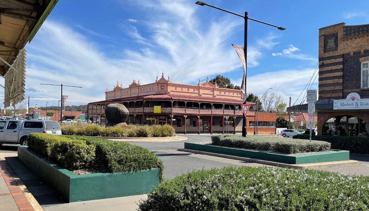 A City Street with A Large Building in The Background and A Green Planter in The Foreground — Stihl Shop Grafton in Glen Innes, NSW