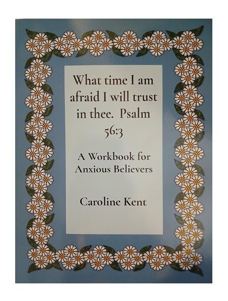 Two smiling people holding books labeled 