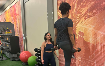 Three men are posing for a picture and one has a tattoo on his arm that says relentless
