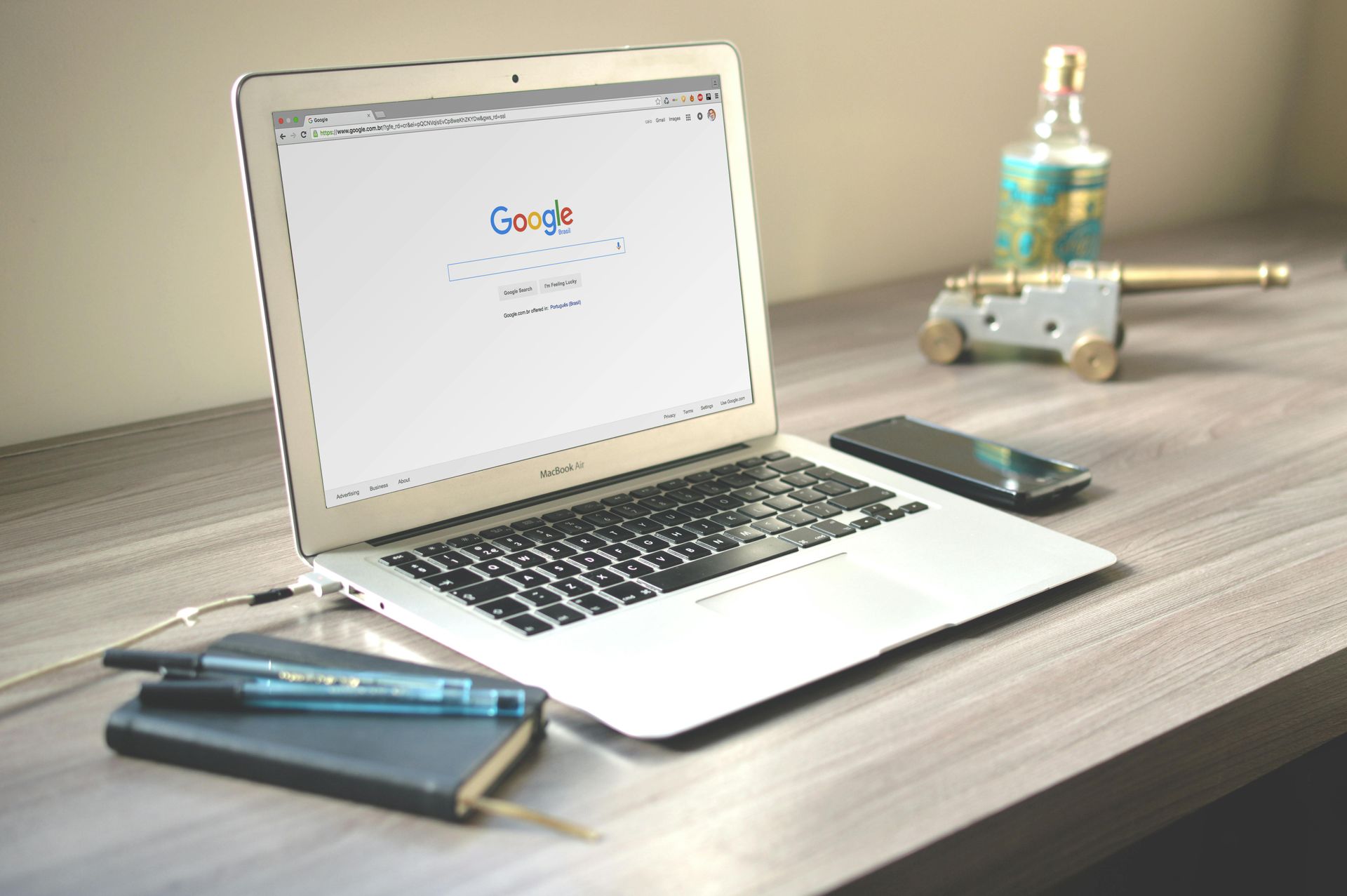 A laptop is open to a google page on a desk.