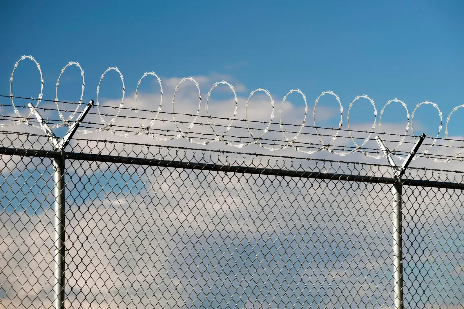 Black metal fence with vertical bars, likely used as a barrier.