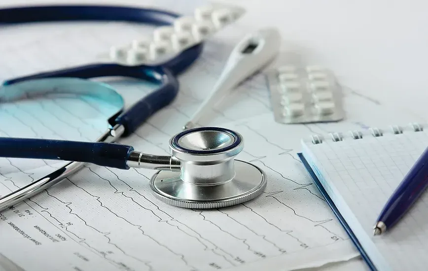 A stethoscope is sitting on top of a medical chart