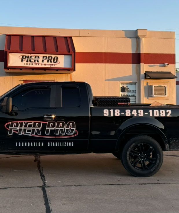 Black truck with "Pier Pro Foundation Stabilizing" parked outside a building. Phone number visible: 918-849-1092.