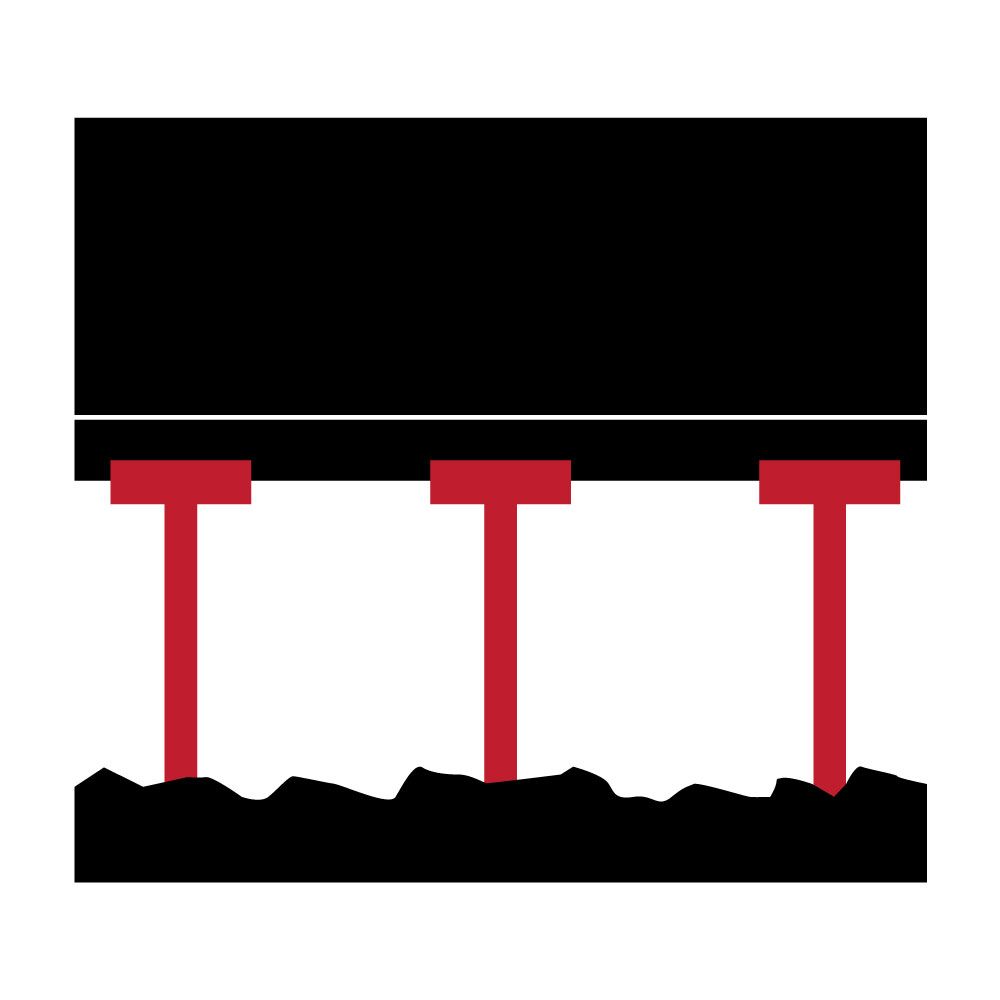 Black rectangle supported by red pillars on rocky ground.