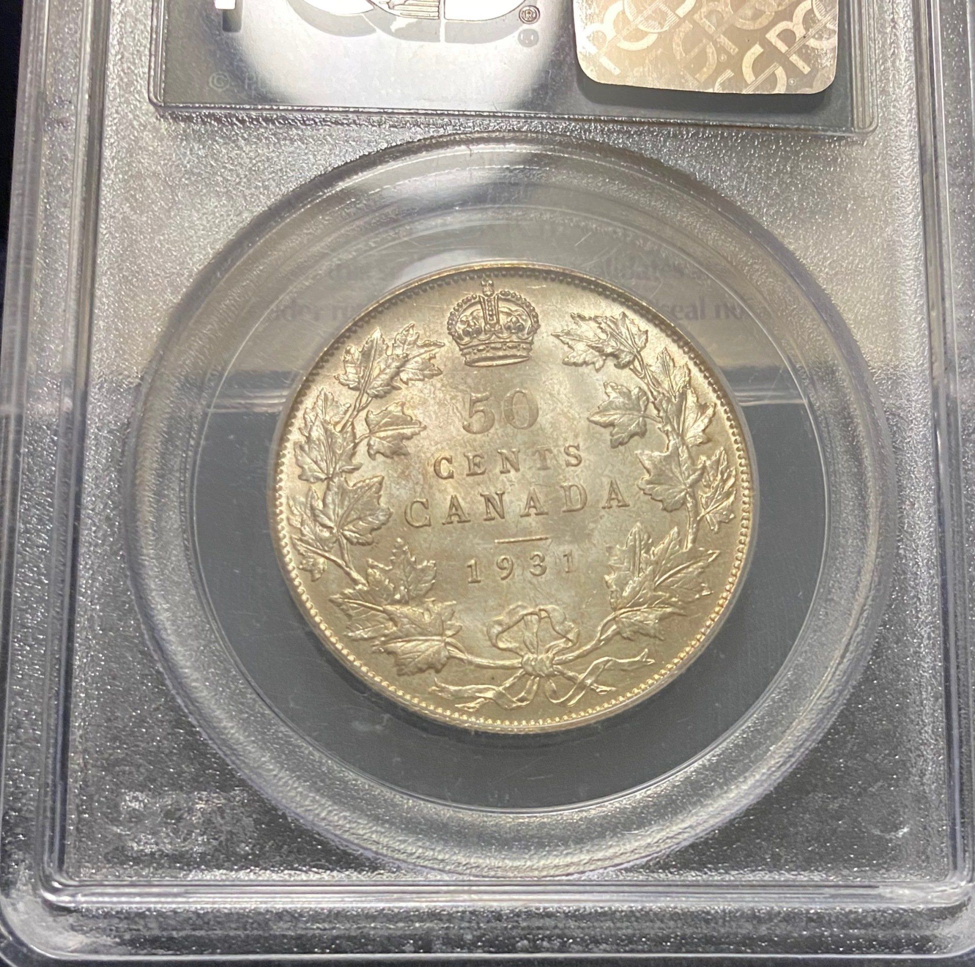 A 50 cent canadian coin in a clear case