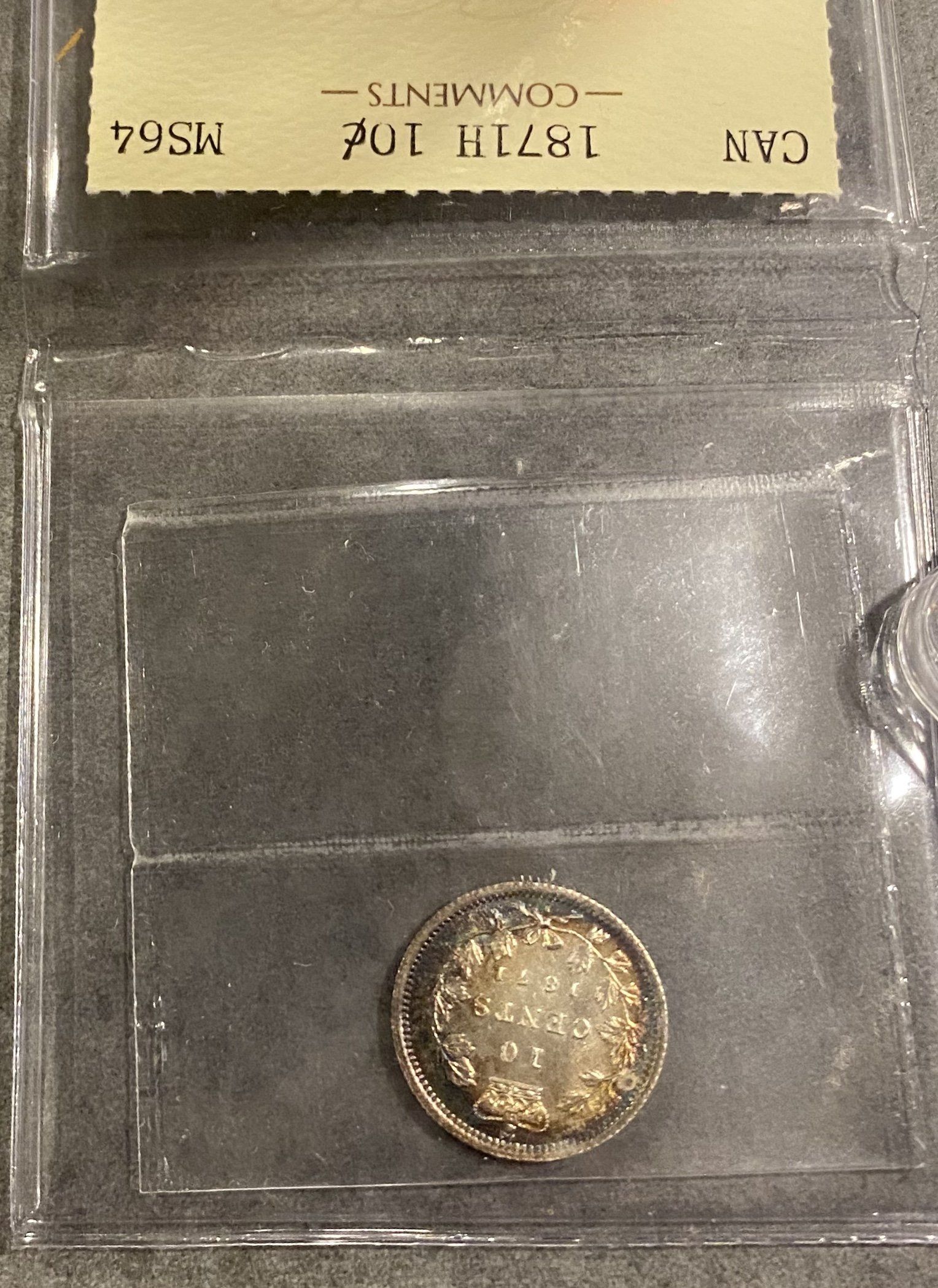 A close up of a coin in a plastic case