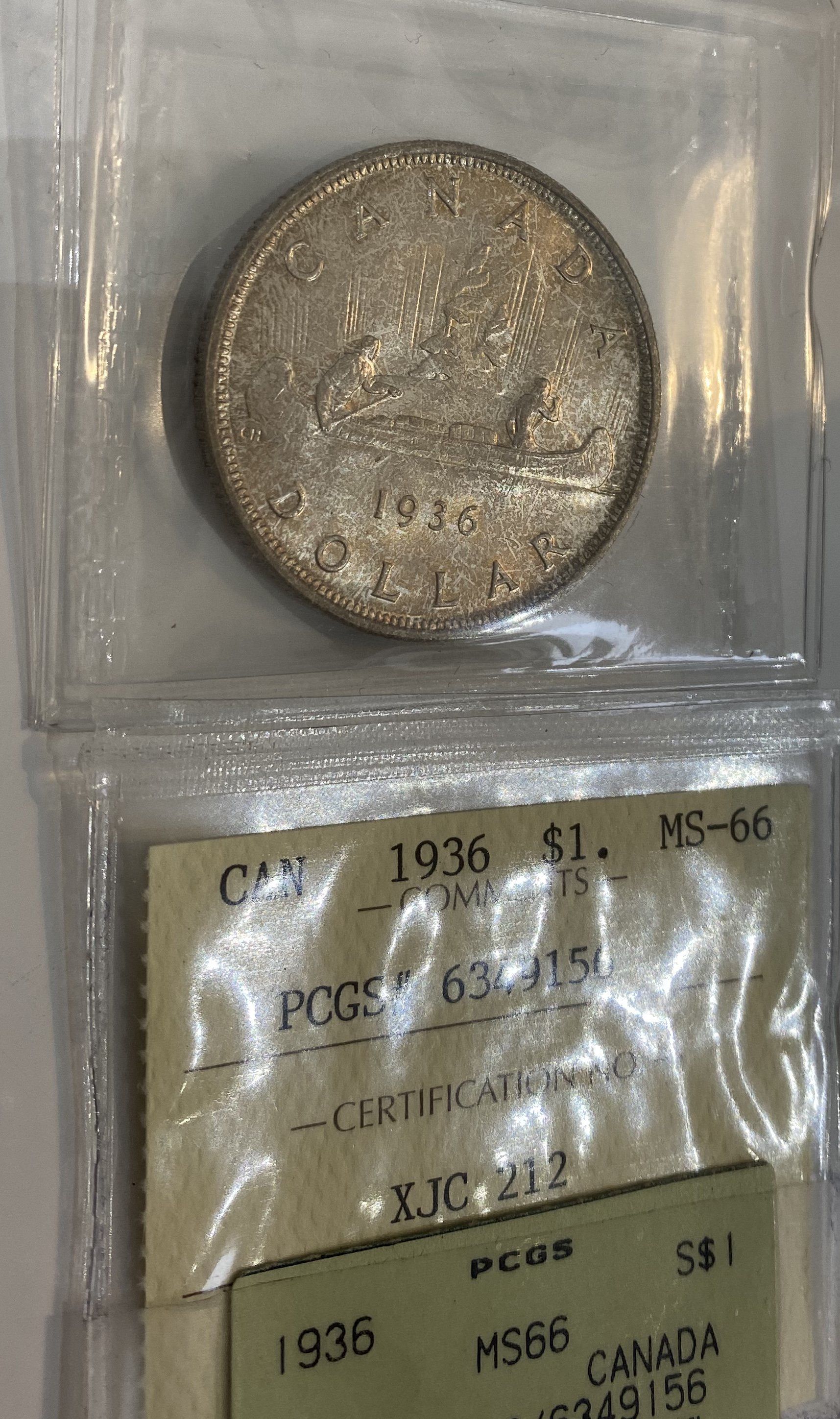 A silver coin from 1936 is in a plastic bag