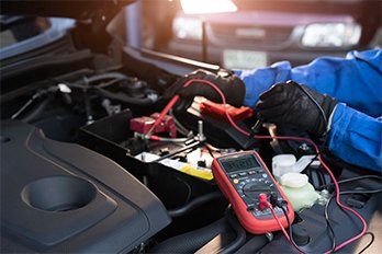 Technician Measure Voltage of Battery — Logan, UT — Intermountain Cooling Systems