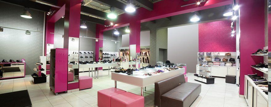 A shoe shop decorated in cream, black and fuchsia pink