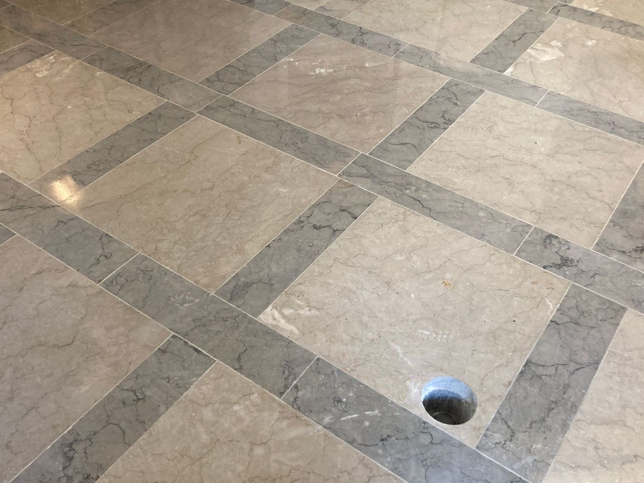 A marble floor with a hole in the middle of it.