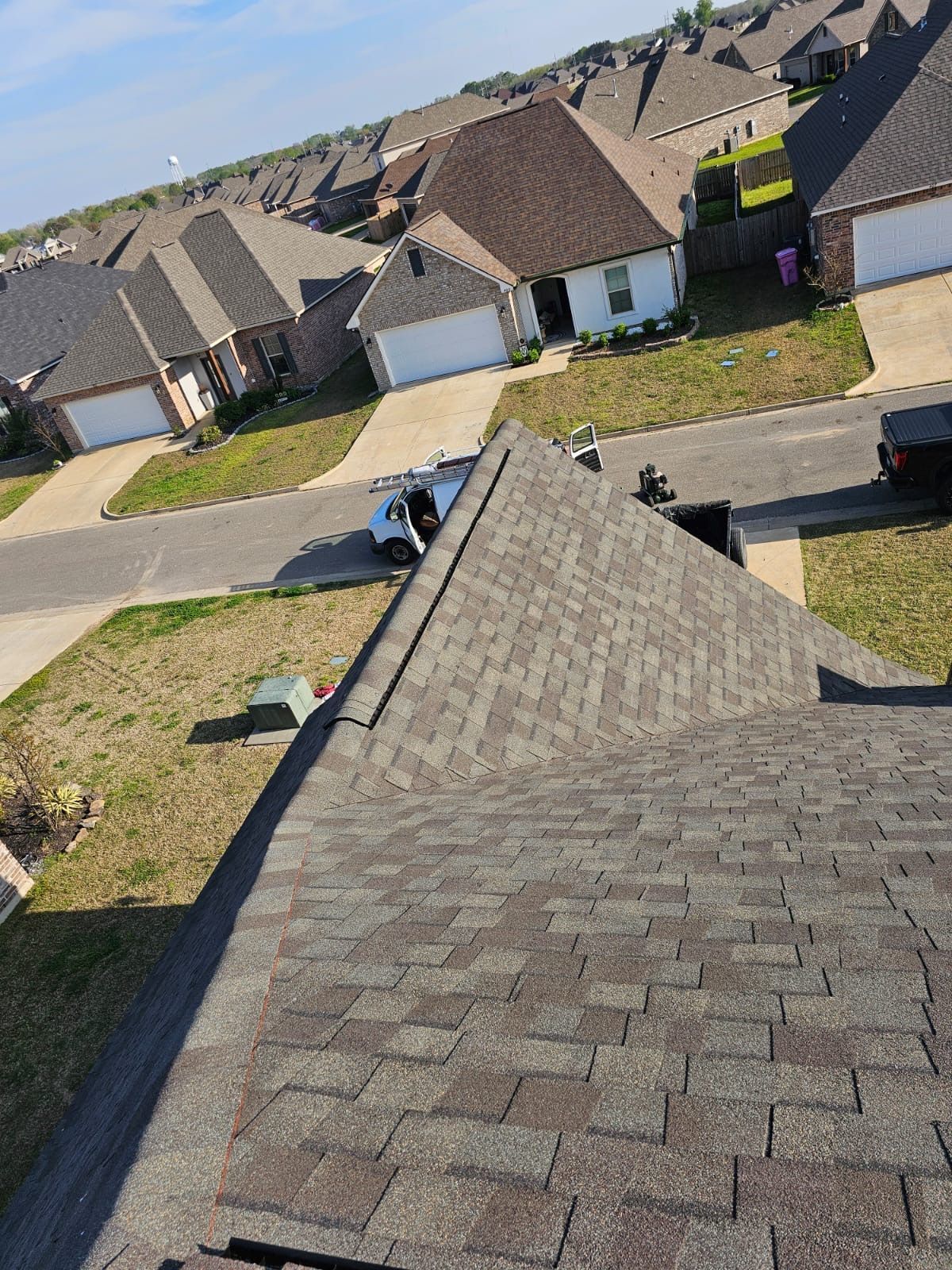 An aerial view of a roof of a house in a residential area.