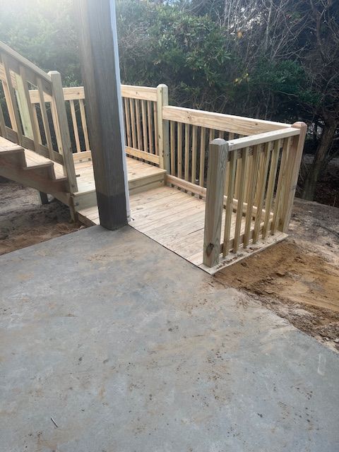 Wooden ramp and stairs with railings for accessibility, outdoors.
