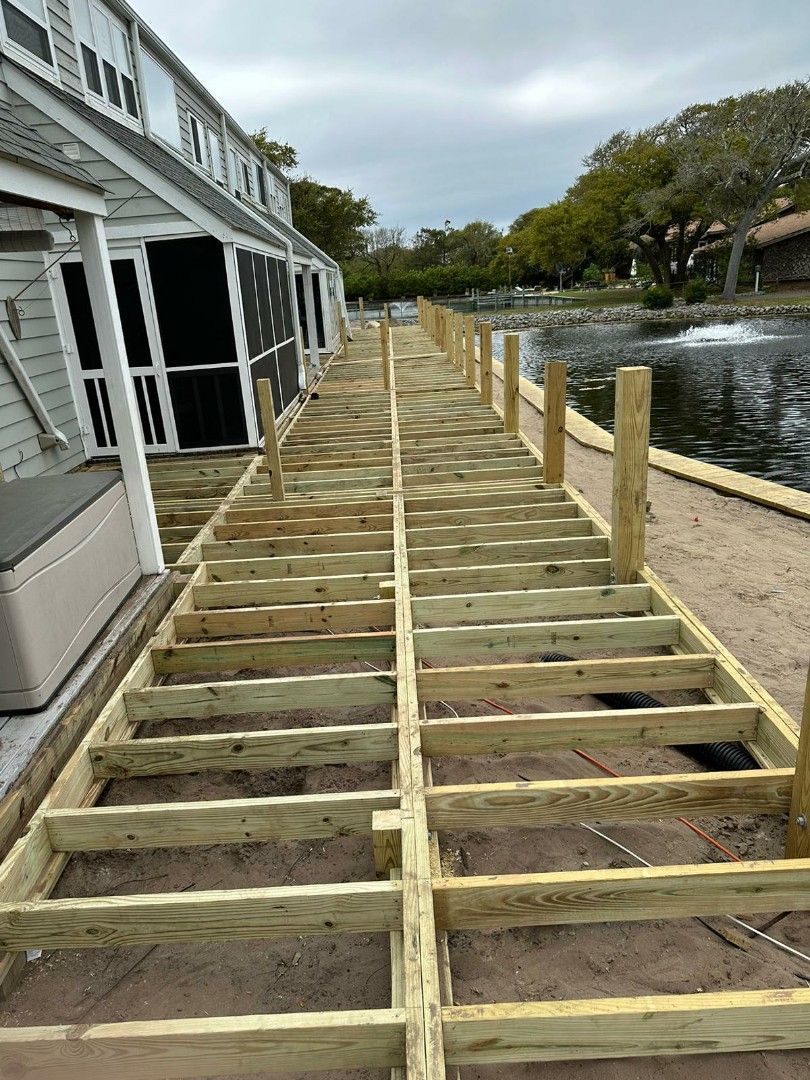 Wooden boardwalk leading to the beach and ocean on a sunny day.
