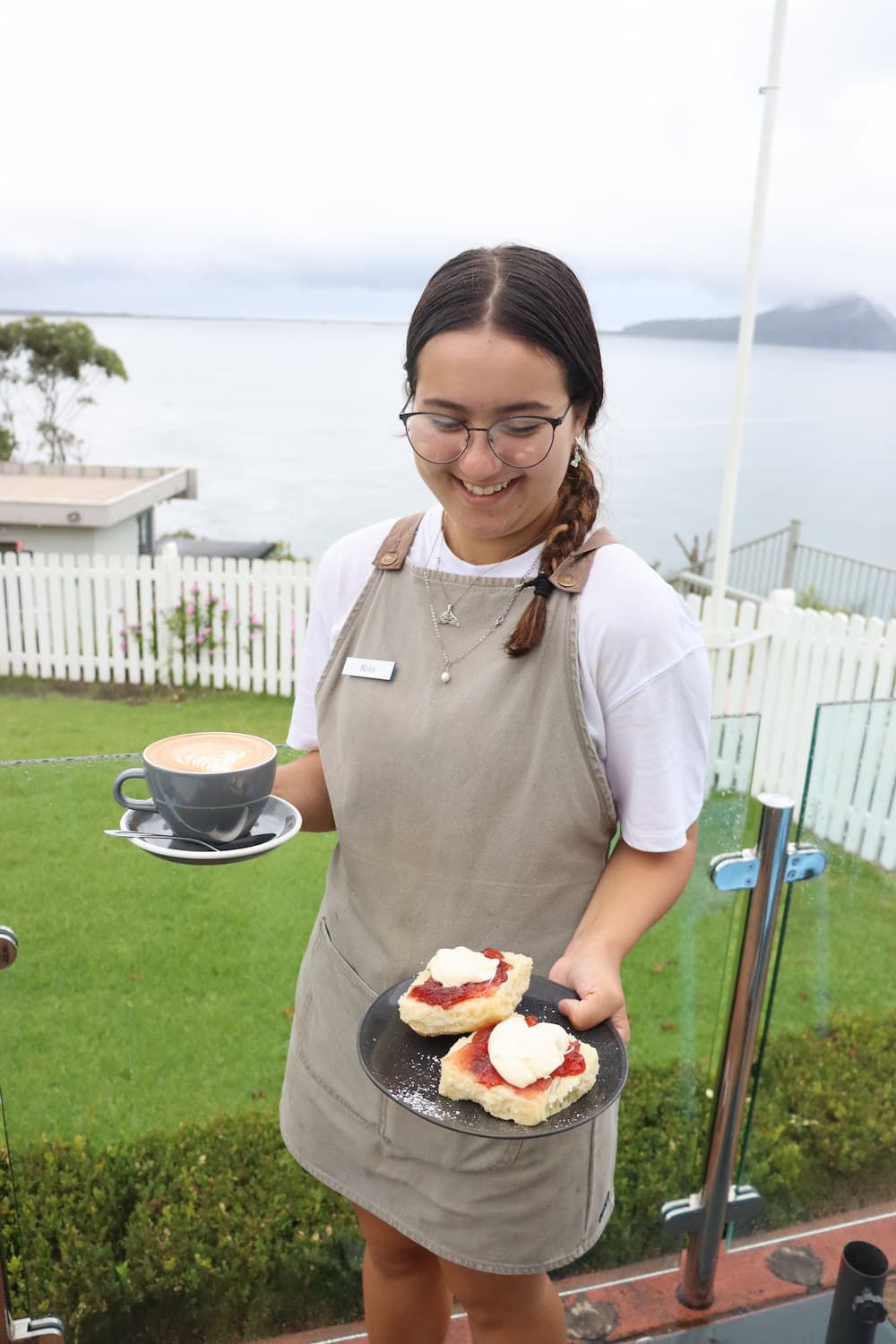 Woman Holding A Plate With Scones — A Nice Café in Nelson Bay