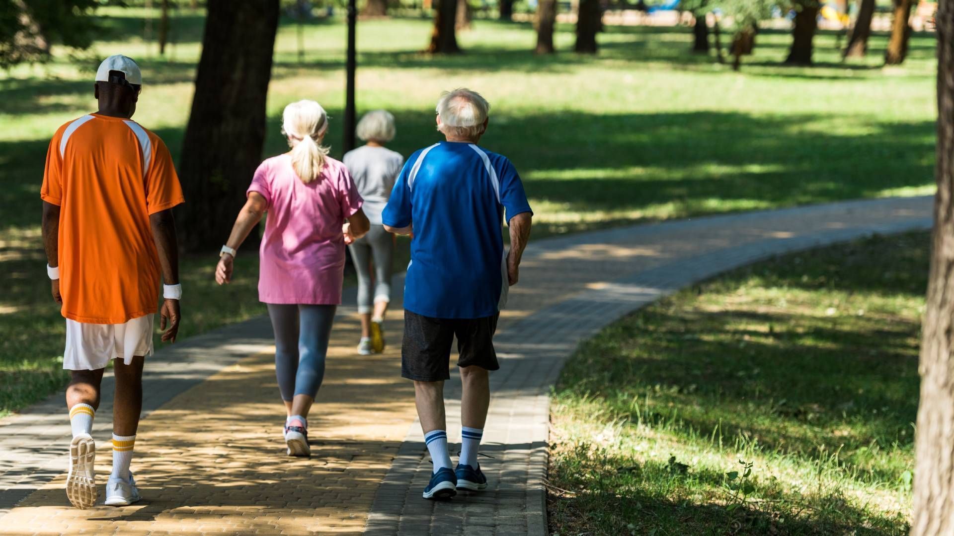 Several people walking down a nice path in the shade at Family Choice Home Care near Lexington, Kent