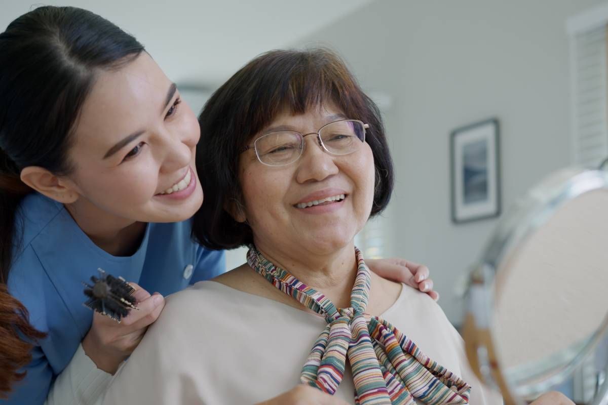 An in-home caregiver helping a senior with their morning routine near Lexington, Kentucky