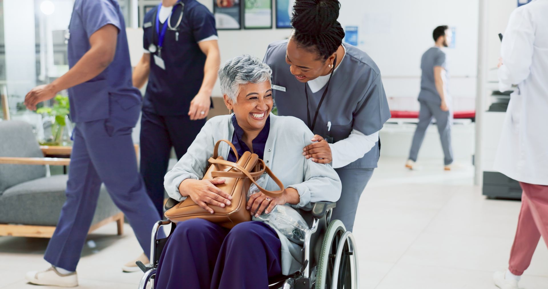 Doctor and woman in wheelchair in lobby for discharge before transitional care near Lexington, Kentucky.