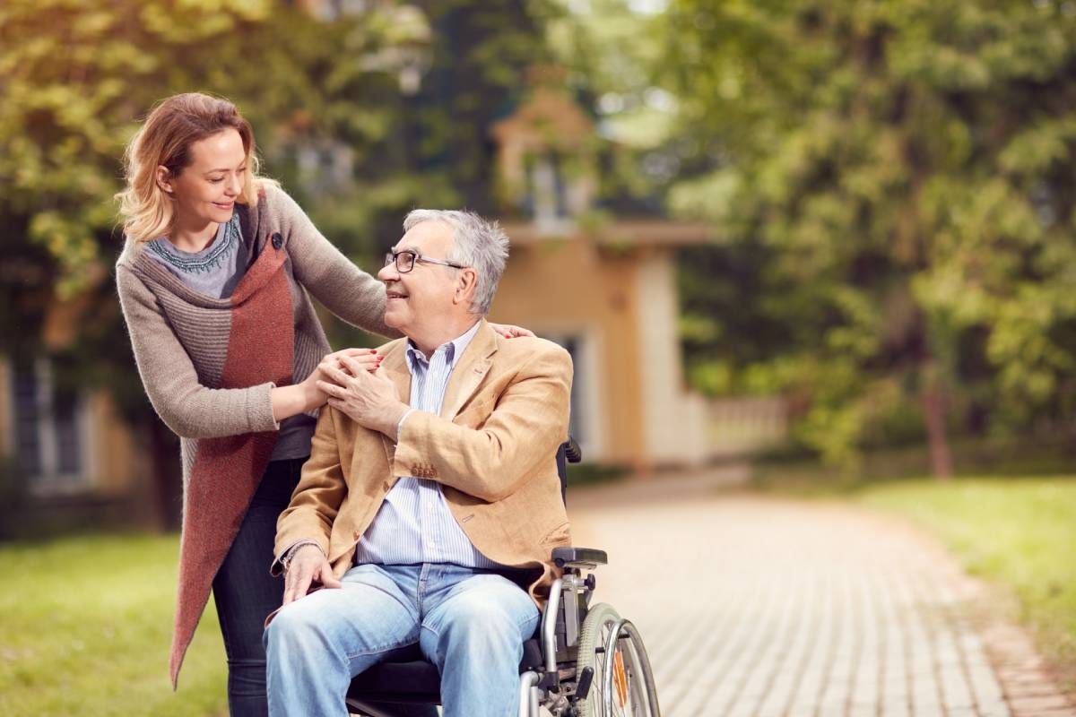 A senior in a wheelchair with a caregiver looking at each other at Family Choice Home Care near Lexington, Kentucky