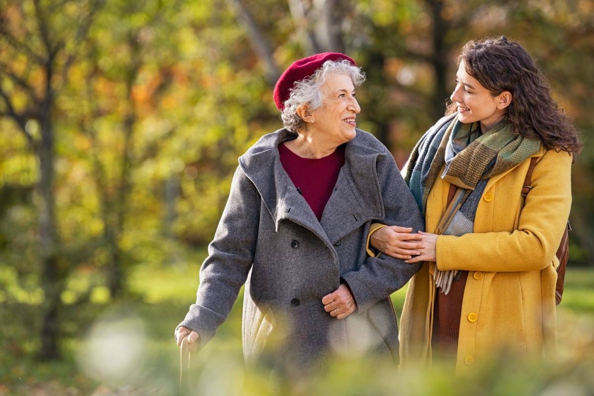 A caregiver and a senior walking on a brisk fall morning at Family Choice Home Care near Lexington, Kentucky