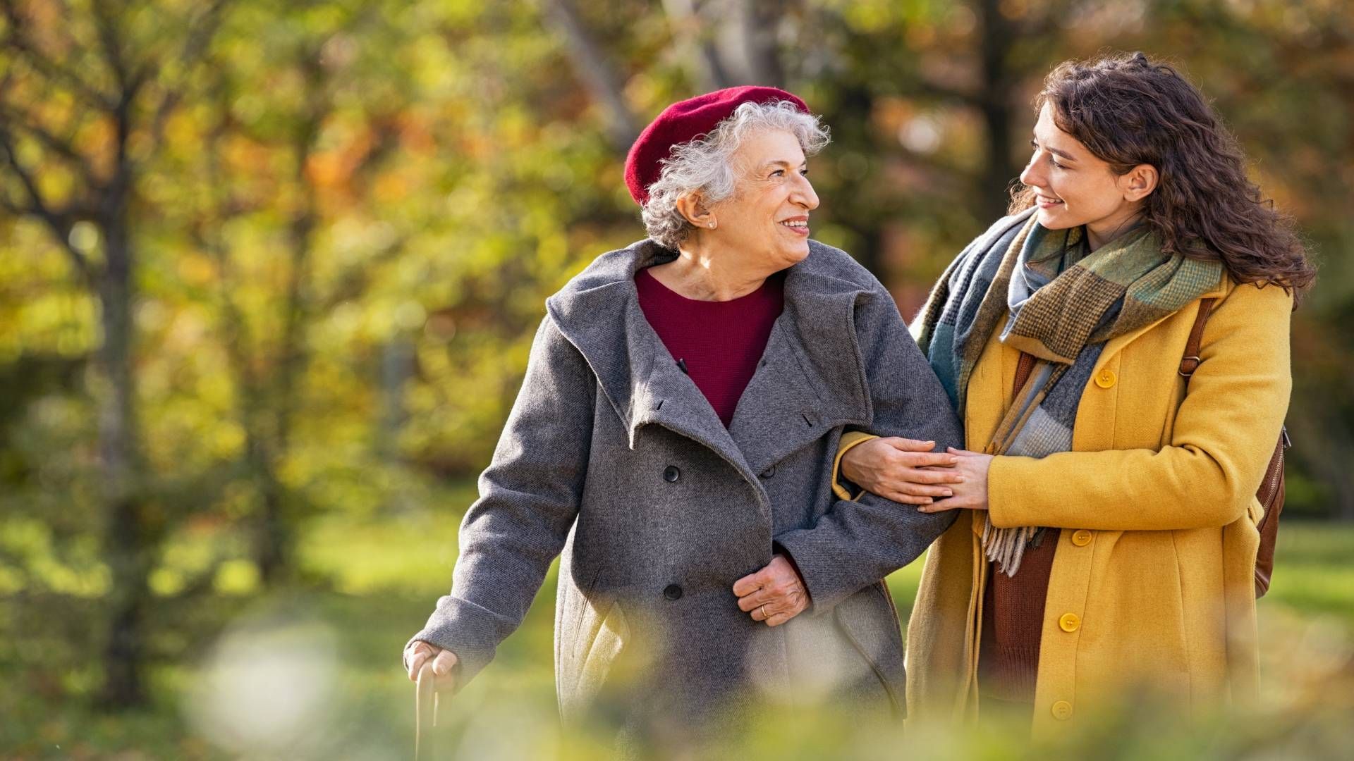 A caregiver and a senior walking on a brisk fall morning at Family Choice Home Care near Lexington, 