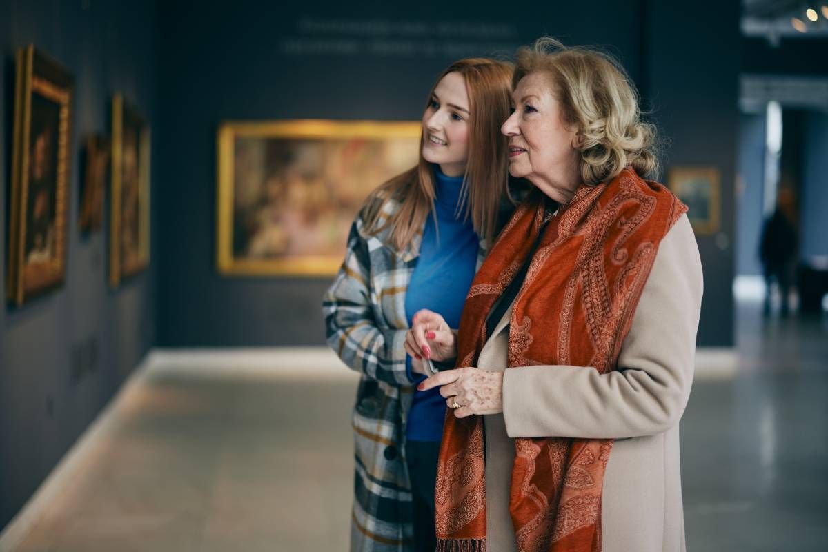 Two people visiting an art gallery and looking at a painting together at Family Choice Home Care near Lexington, Kentucky