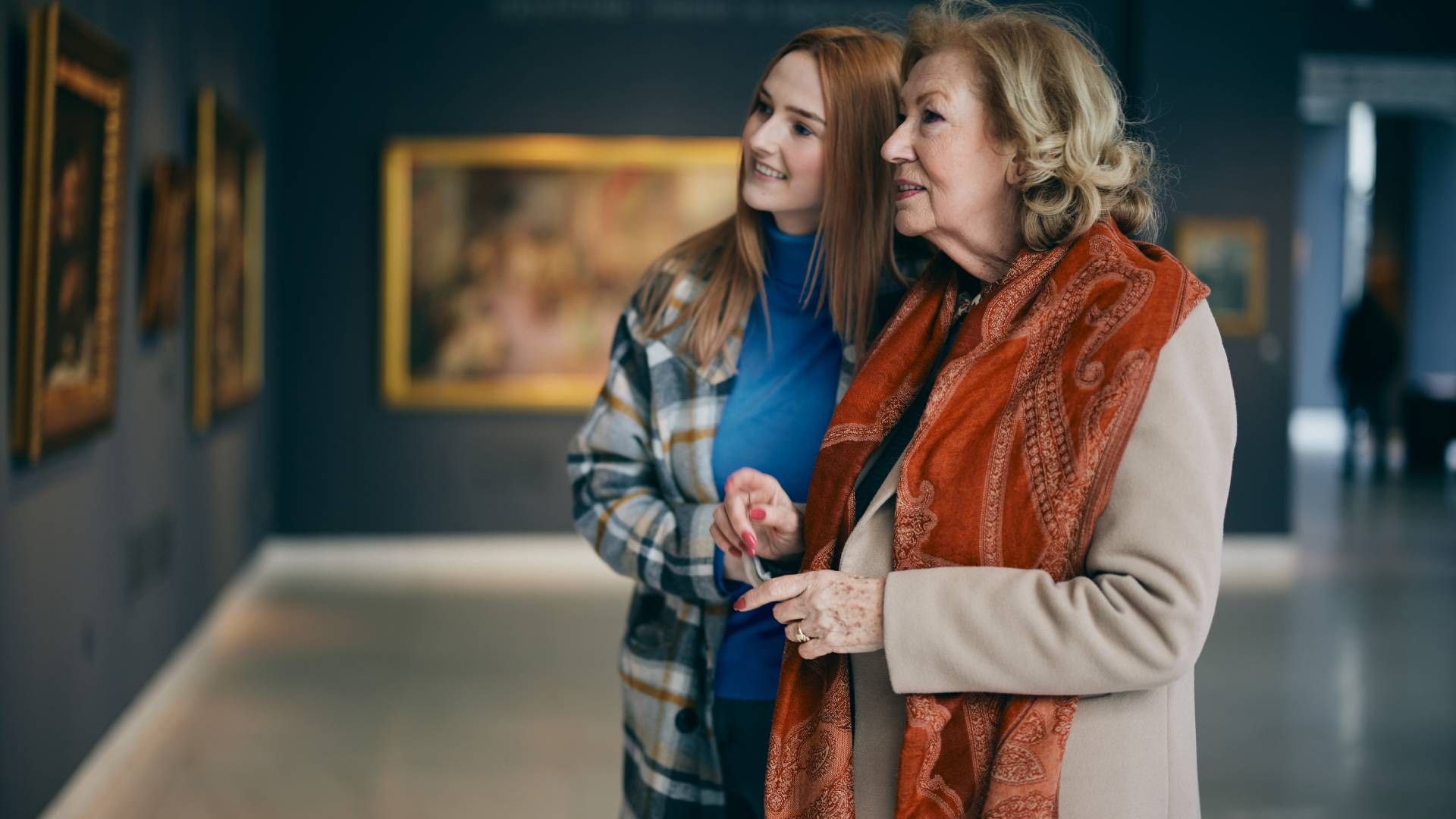 Two people visiting an art gallery and looking at a painting together at Family Choice Home Care nea