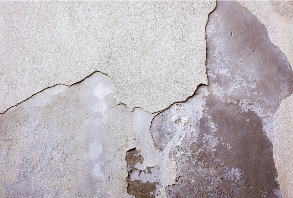 Visible drywall cracks and holes showing signs of needed repair in a Hanford home