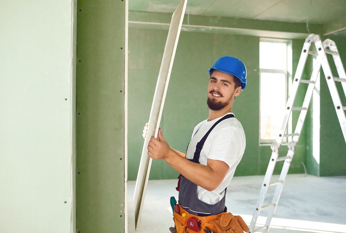 Drywall specialist working carefully on an interior repair project in Hanford
