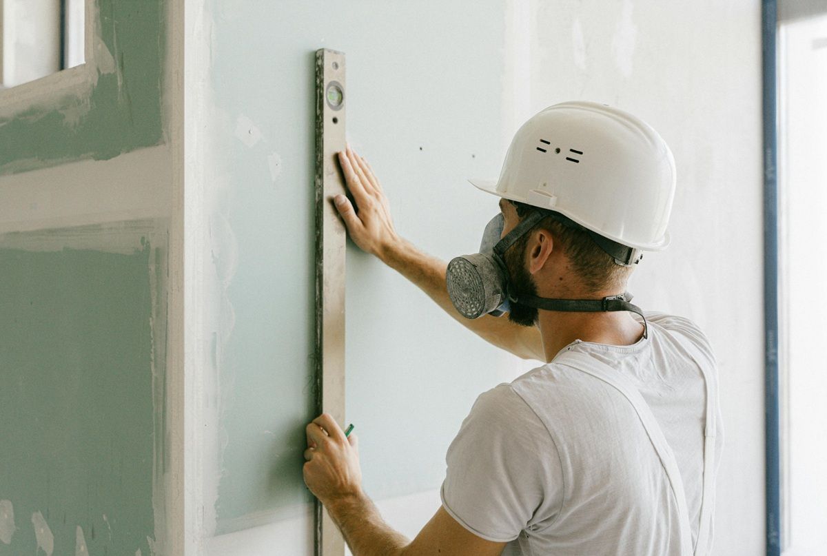 Technician assessing drywall damage before preparing a repair estimate in Hanford, CA