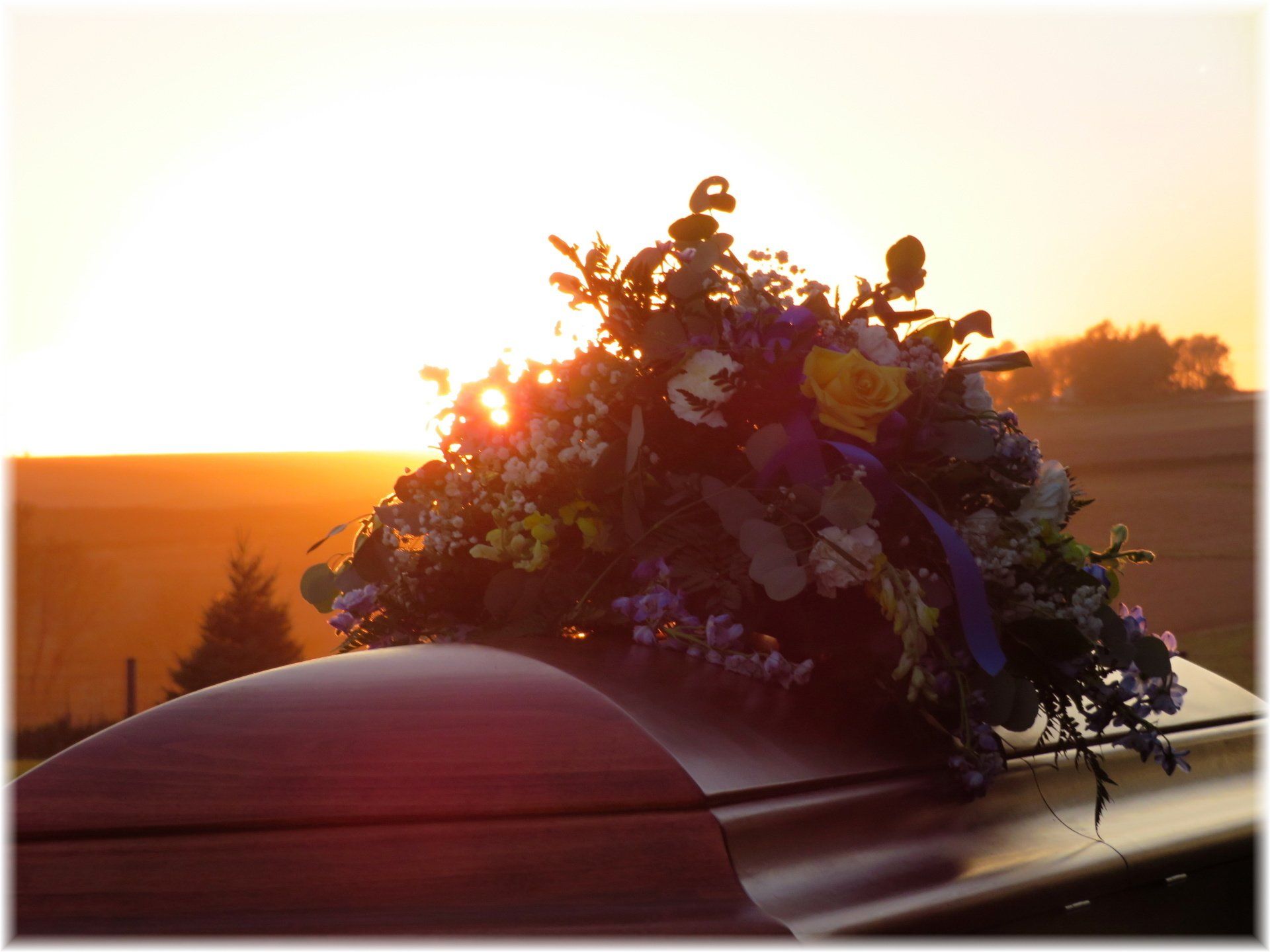 Funeral Home — A Casket with Bunch of Flowers Above in Atlantic, IA