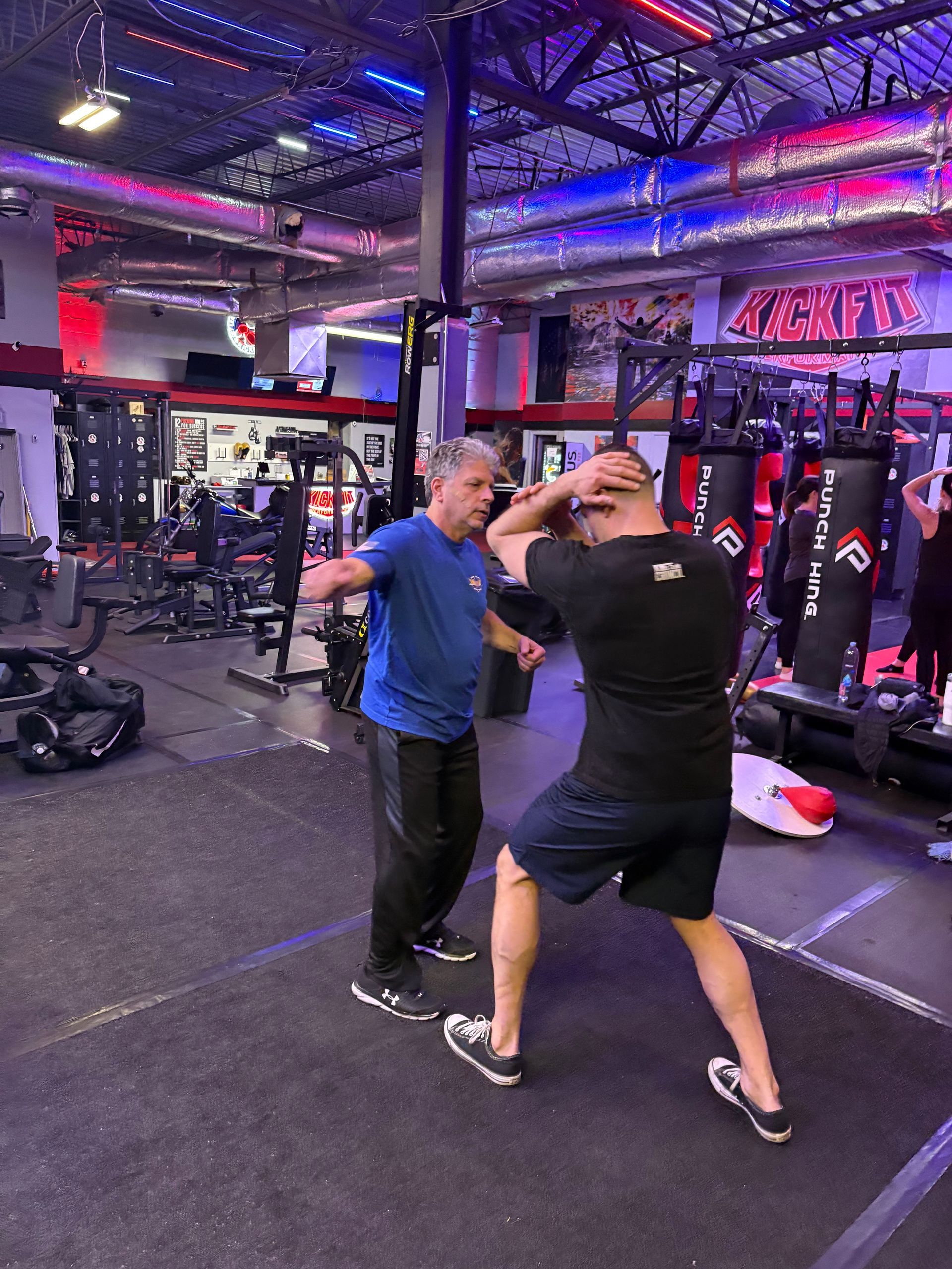 Adults practicing Krav Maga drills at Storm Krav Maga in Bohemia, NY to build calm, lasting resilience.