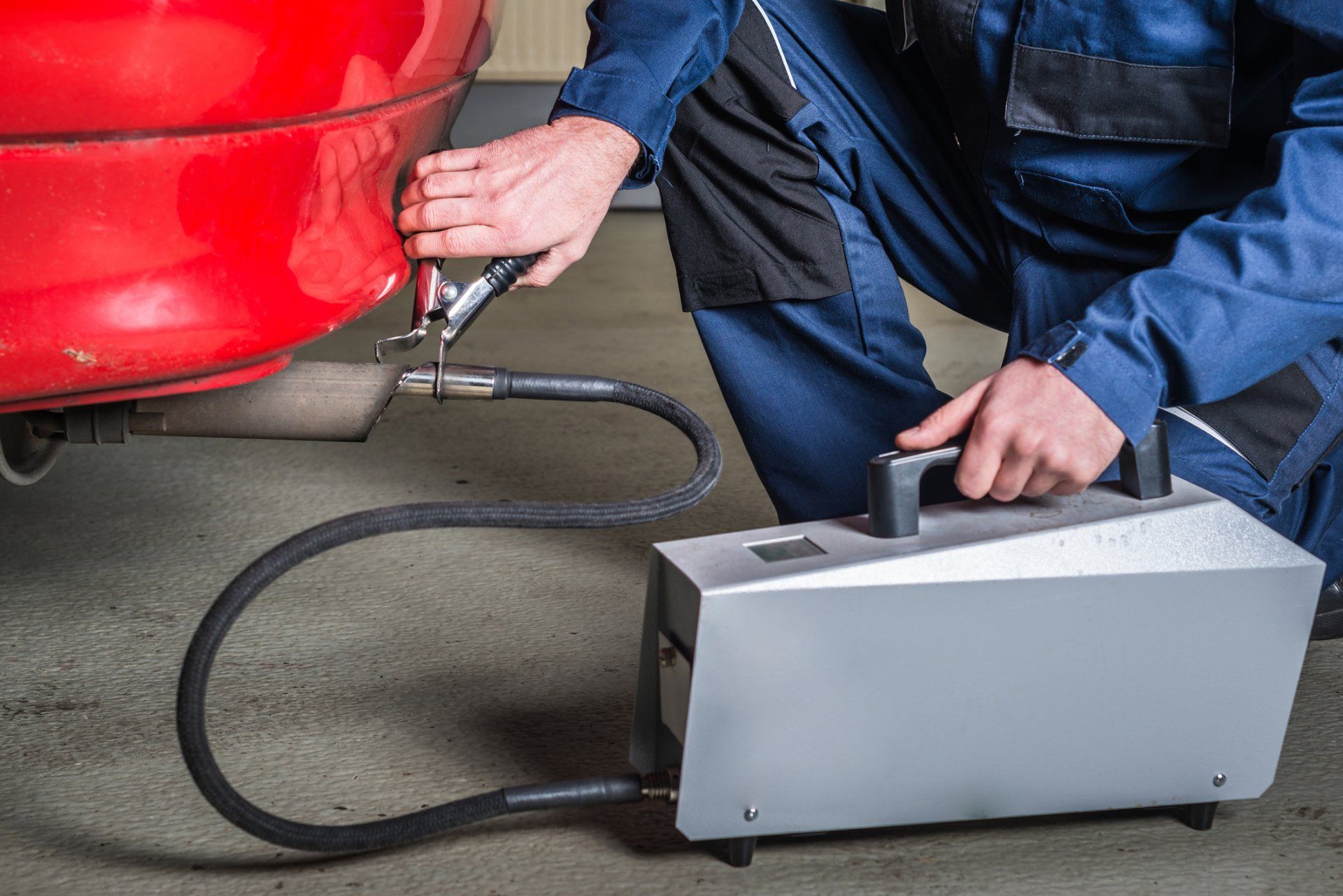 Muffler Shop — Diagnostic Sensor Applied to the Exhaust of Red Car in Tucson, AZ