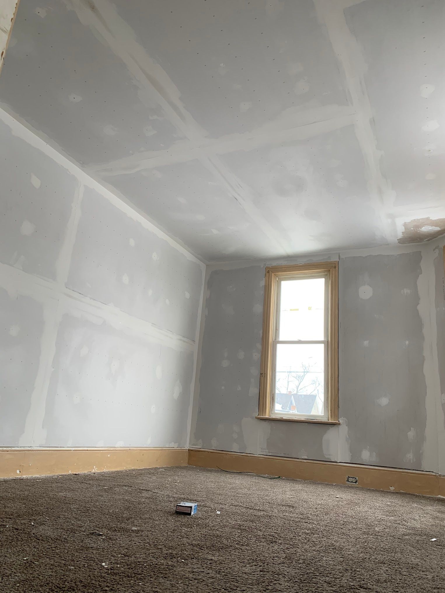 There is a window in the corner of the room.